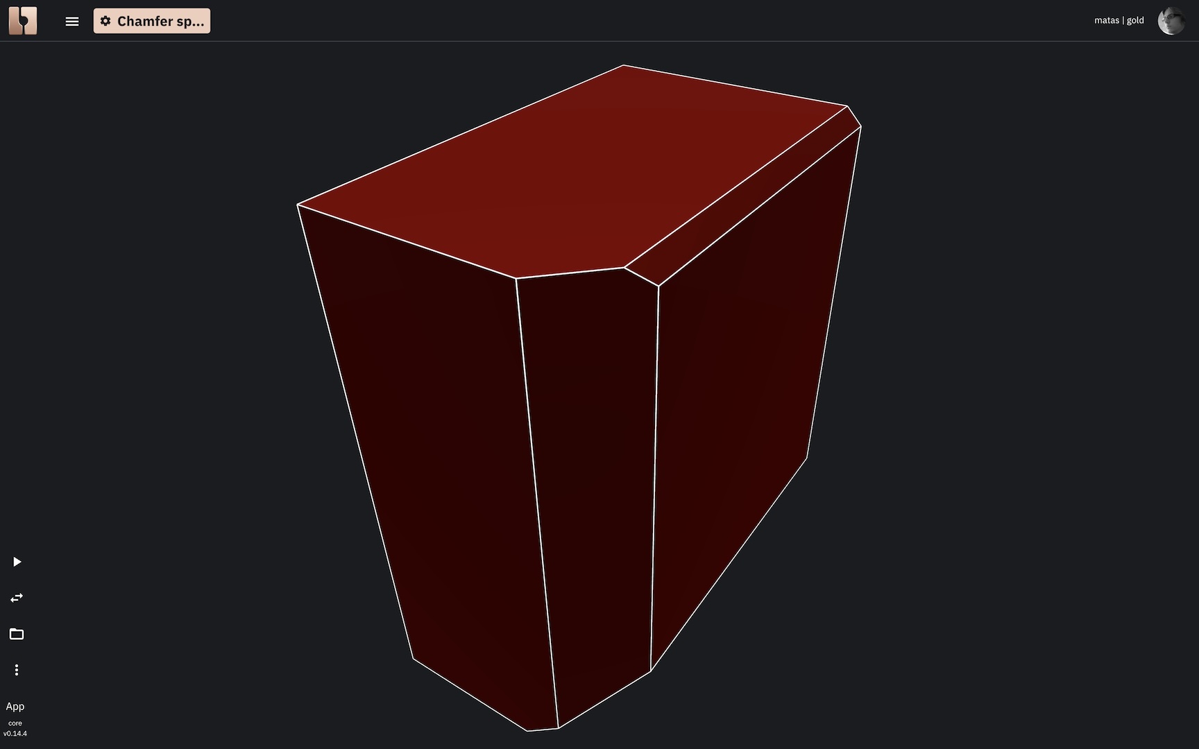 A 3D solid box with chamfers of varying distances applied to different edges, creating a mix of larger and smaller beveled surfaces.
